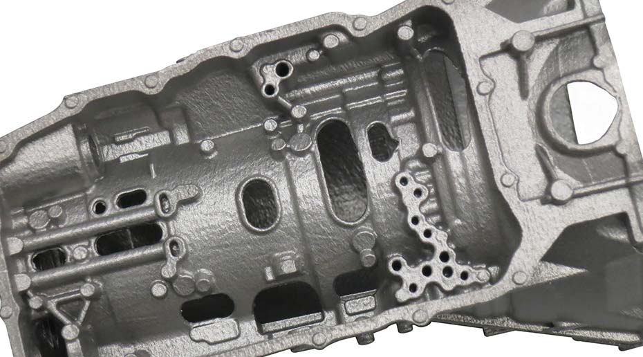 A close up of a complex car part with metallic casing.