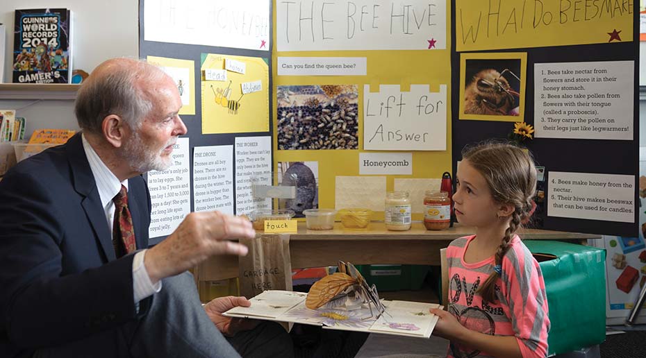 Imaginative Education Research Group founder Kieran Egan talking with third-grader Ashley Srdanovic.