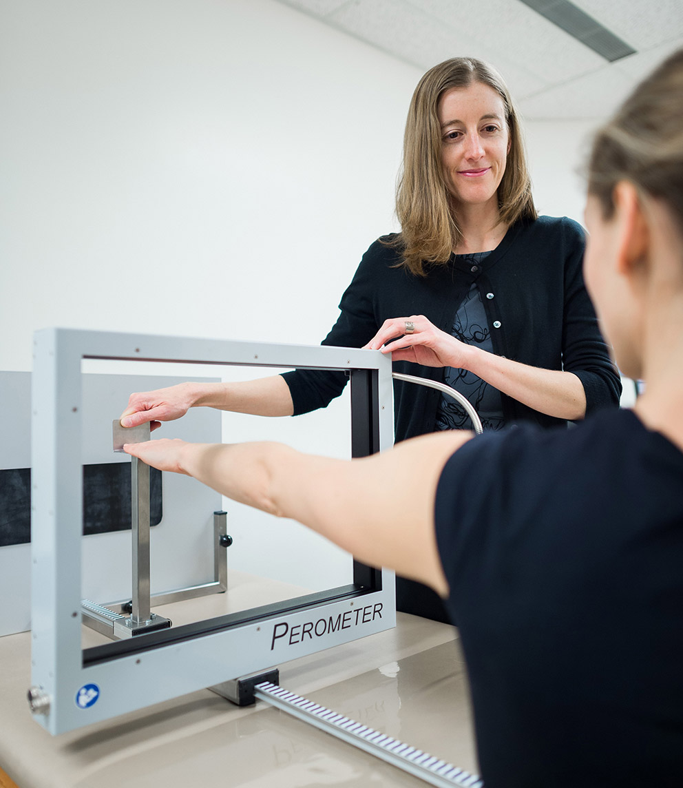 Researcher Kristin Campell using a perometer to measure a patient's arm volume.