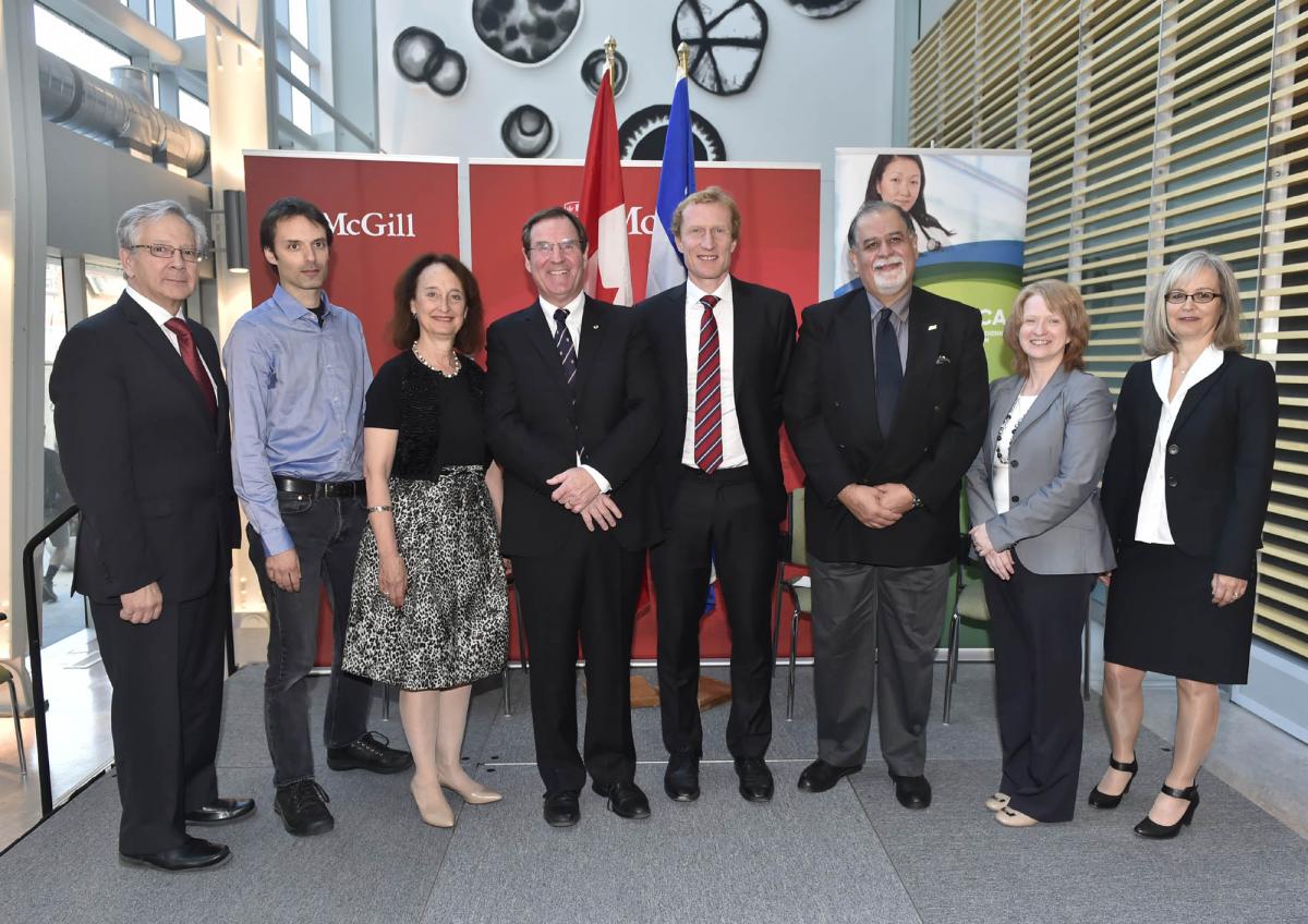 Various executive members posing for a photo at a conference.