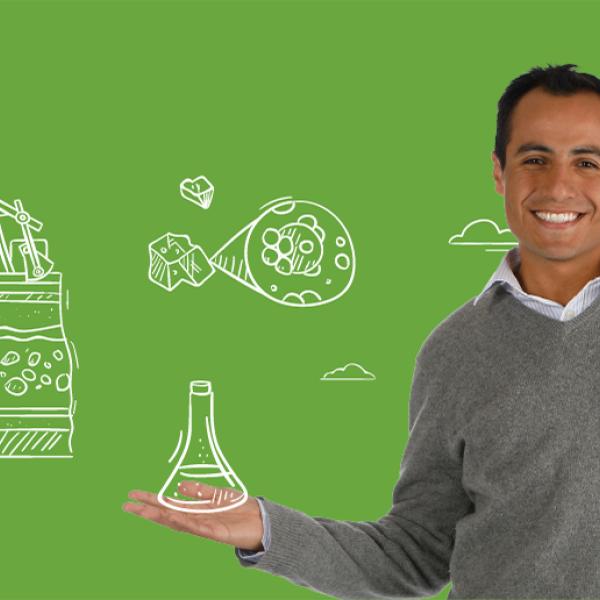 Research associate Luis Alejandro Coy posing for a photo over a green background.