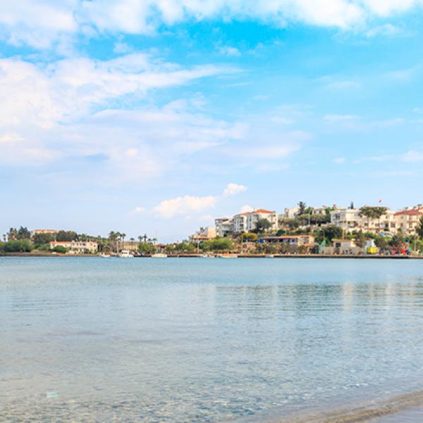 Houses on Datça Peninsula in Turkey surrounded with clear blue water and a sandy beach