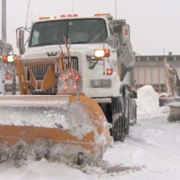 Still from video of two snow removal trucks being deployed