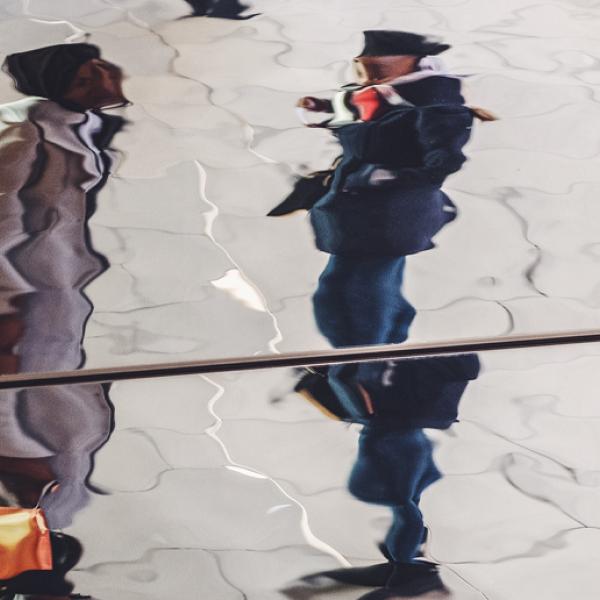 Fractured reflection of two people talking