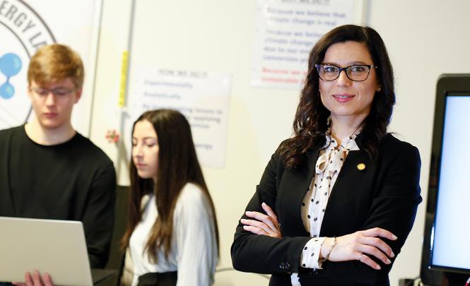 A person poses at a conference