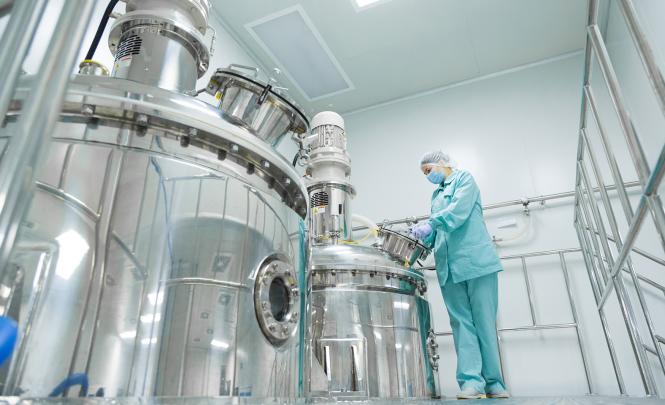 A researcher in protective clothing interacting with research infrastructure