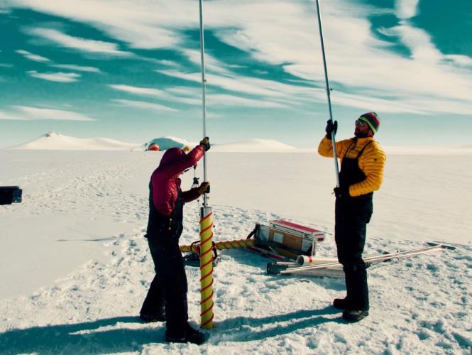 Two researchers using equipment in the field