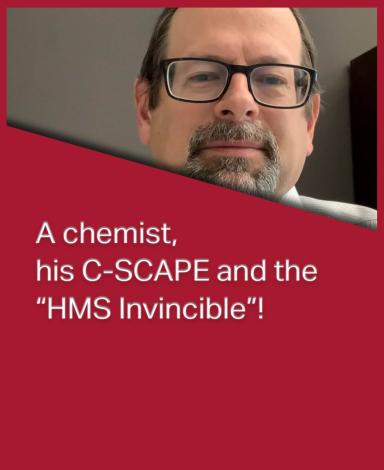 An image card featuring Dr. Doug Goltz inside a red rectangle with the sentence "A chemist, his C-SCAPE and the “HMS Invicible”!" in black text overlayed over it.