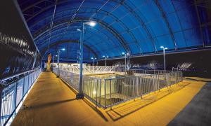 Inside a large domed building with a rectangular fenced-in area in the centre