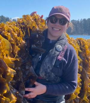 Jennifer Clark standing against a wall of sugar kelp