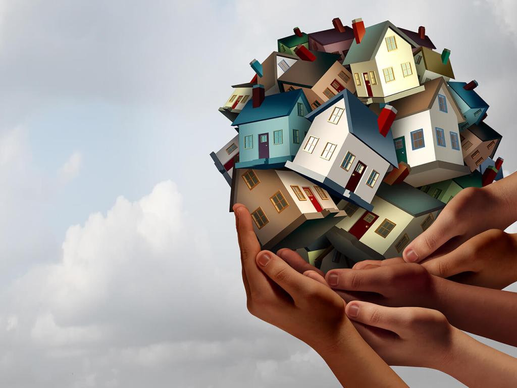 Several hands hold up an illustrated ball of houses against a cloudy sky.