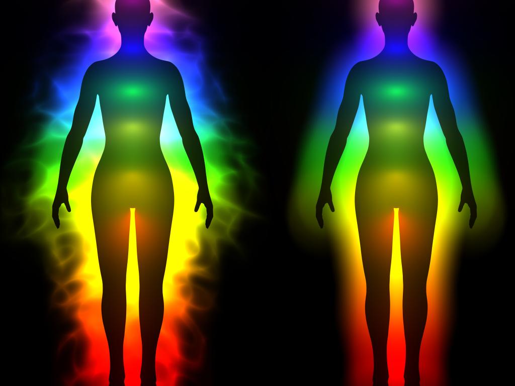 A rainbow of light emanates from two human forms side by side