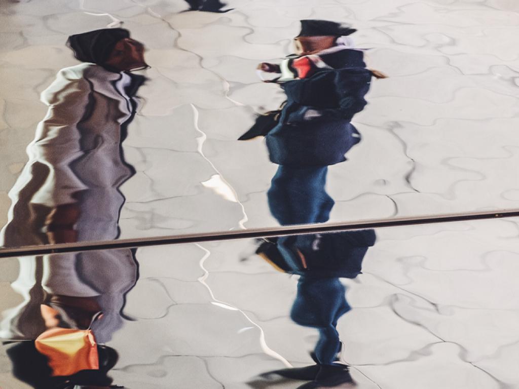 Fractured reflection of two people talking