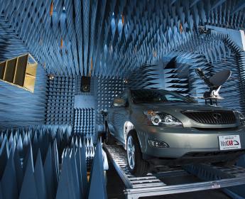 A car parked on a platform inside a chamber with walls covered in foam cones