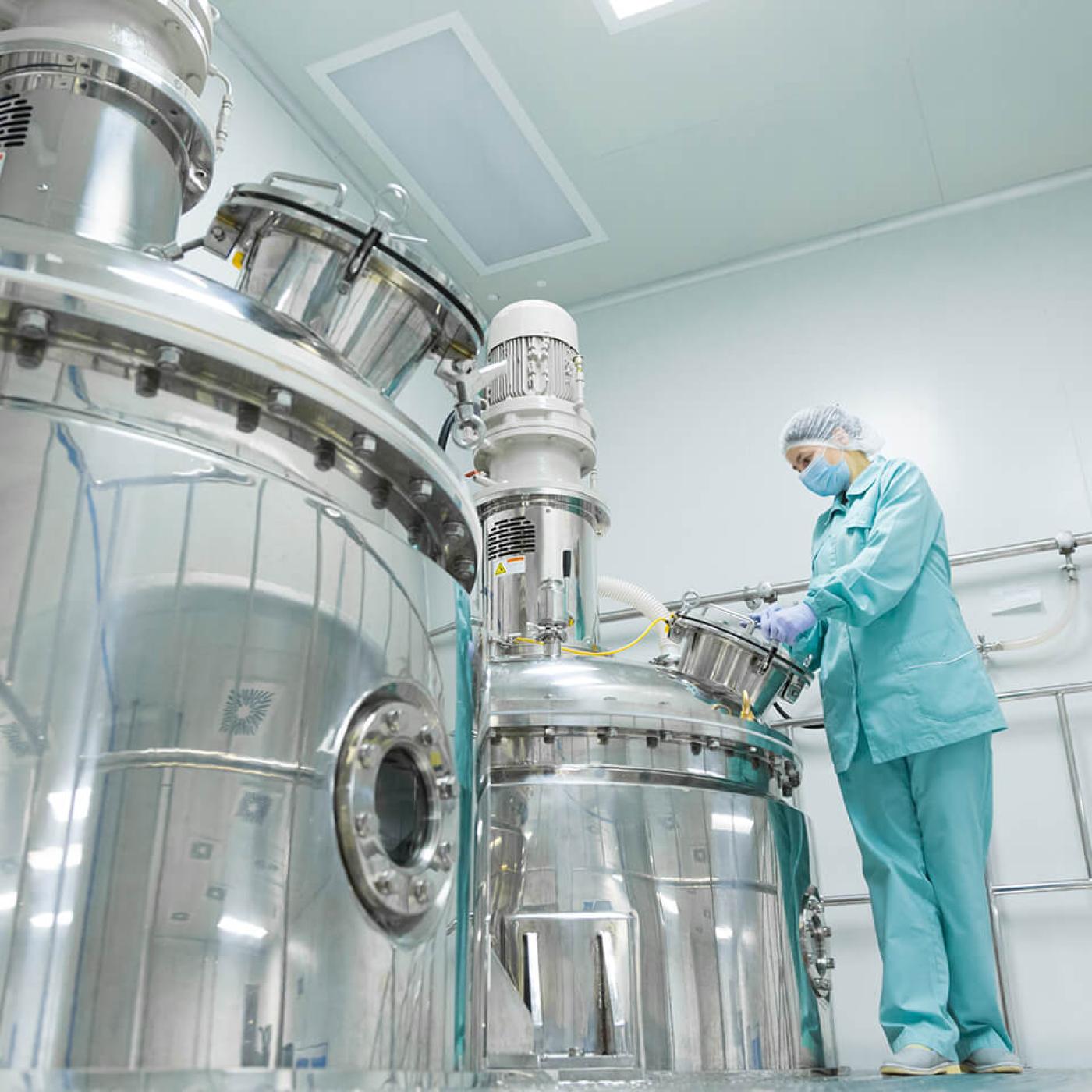 A researcher in protective clothing interacting with research infrastructure