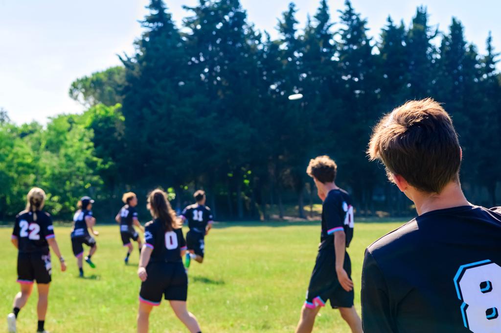 Young people on a soccer field on a sunny day.
