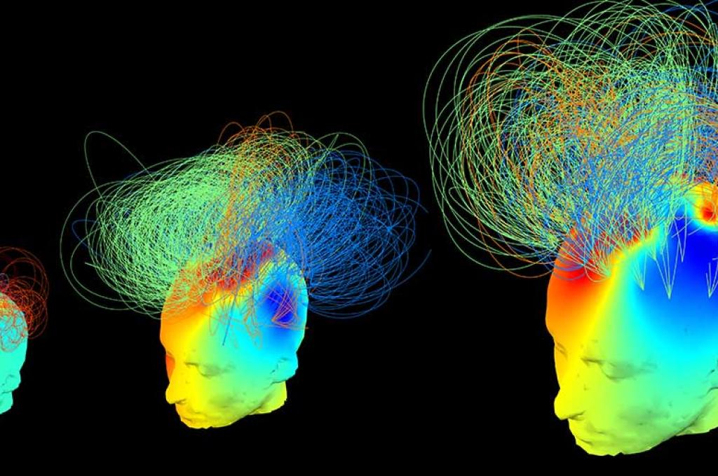 Three diagrams of human heads, generated from data, show areas of the brain lit up with different colours. A series of lines criss-cross above each head – connecting one area to another.