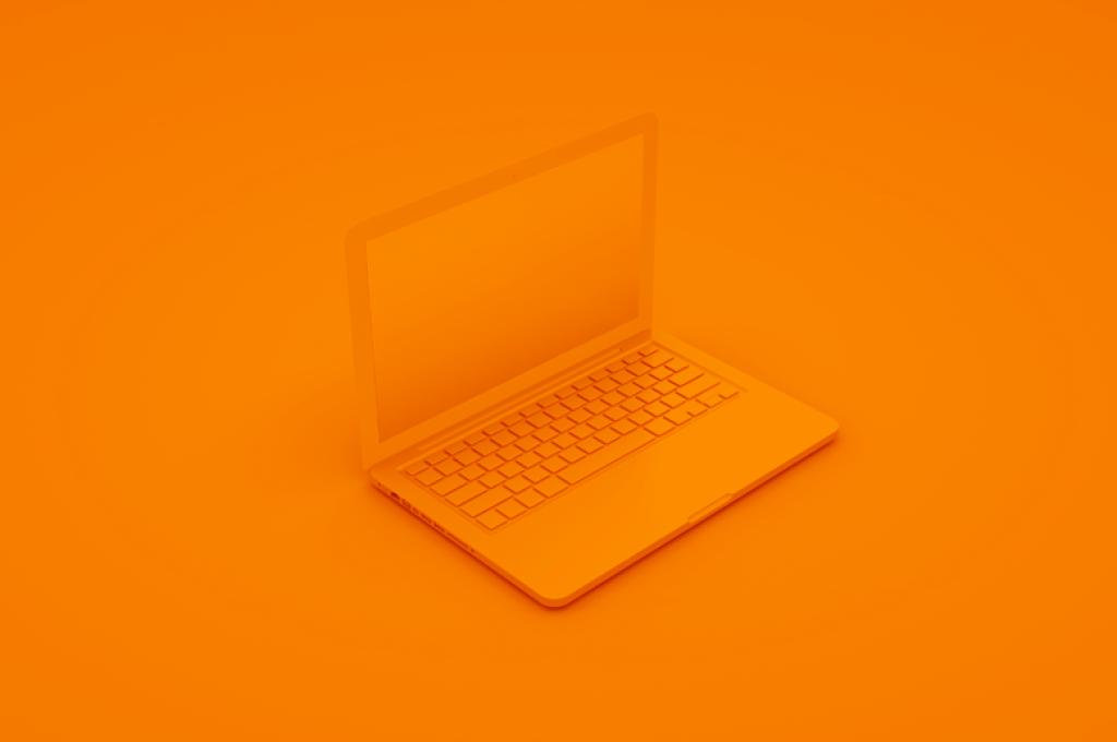 An orange laptop on an orange background