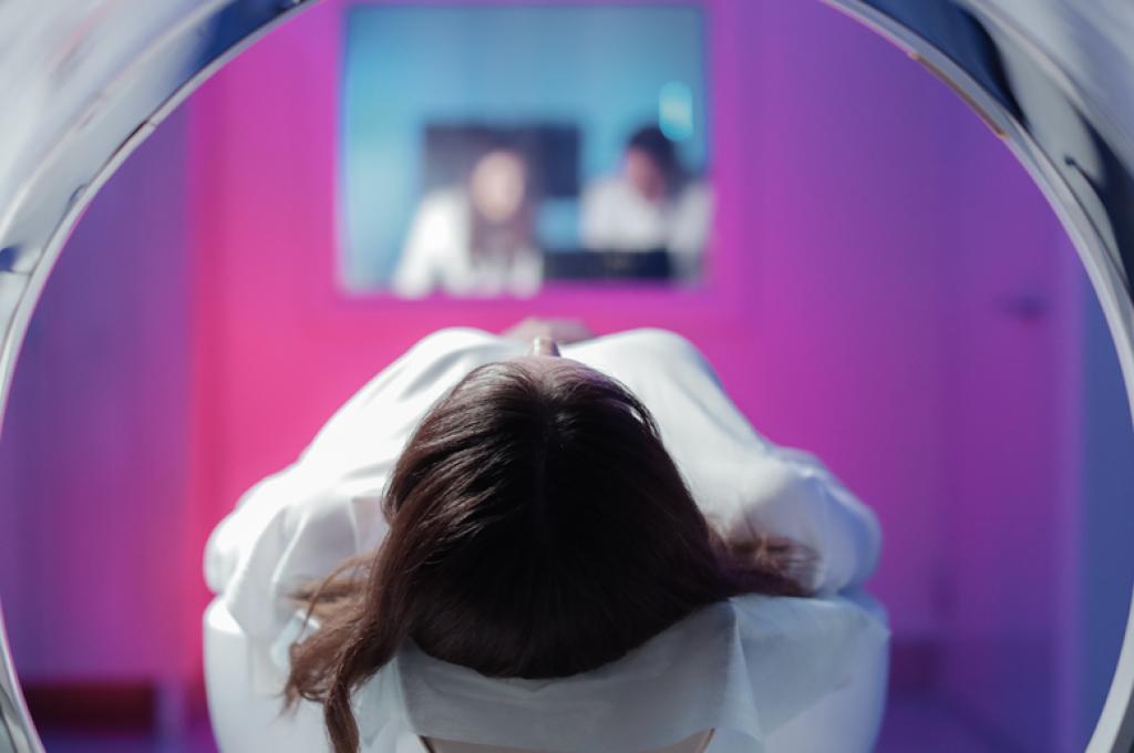 Une vue du sommet de la tête d’une femme à travers le cylindre d’un appareil d’imagerie médicale