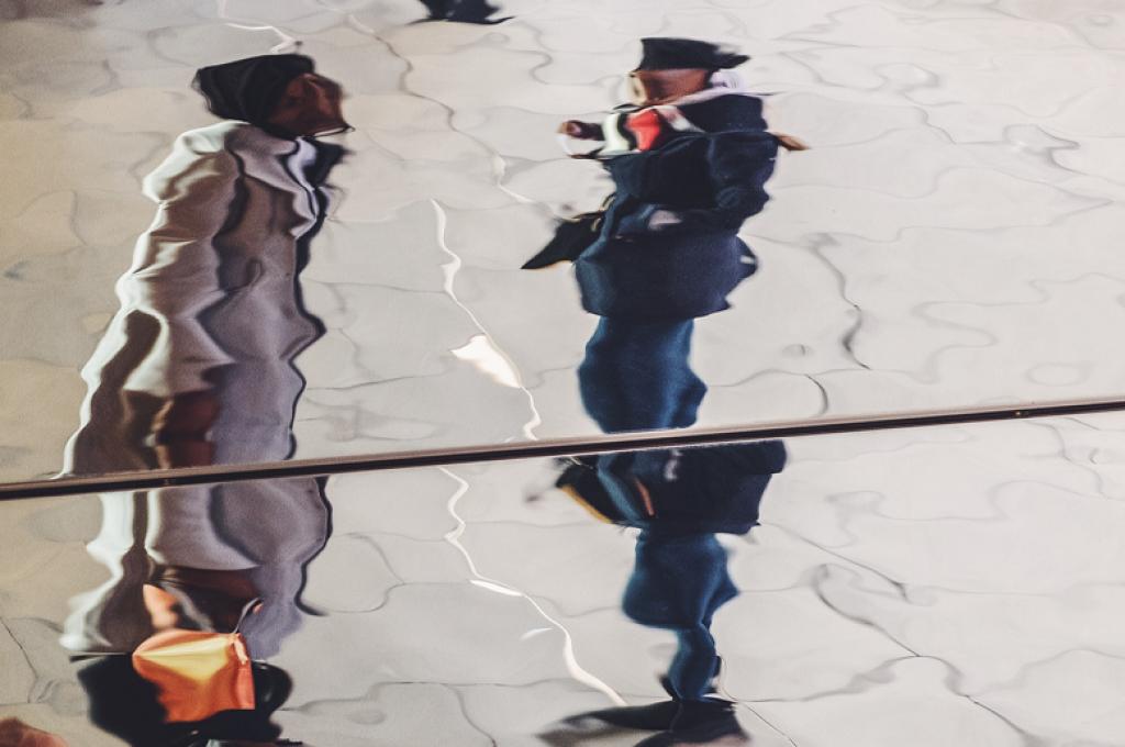 Fractured reflection of two people talking