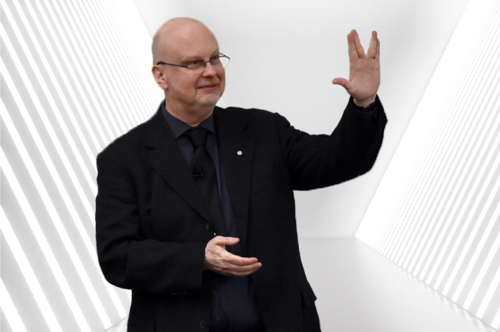 Robert J. Sawyer makes the Vulcan salute to an off-camera audience