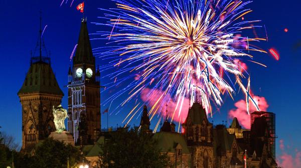 A view of the Parliament Hill of Ottawa with fireworks in the background